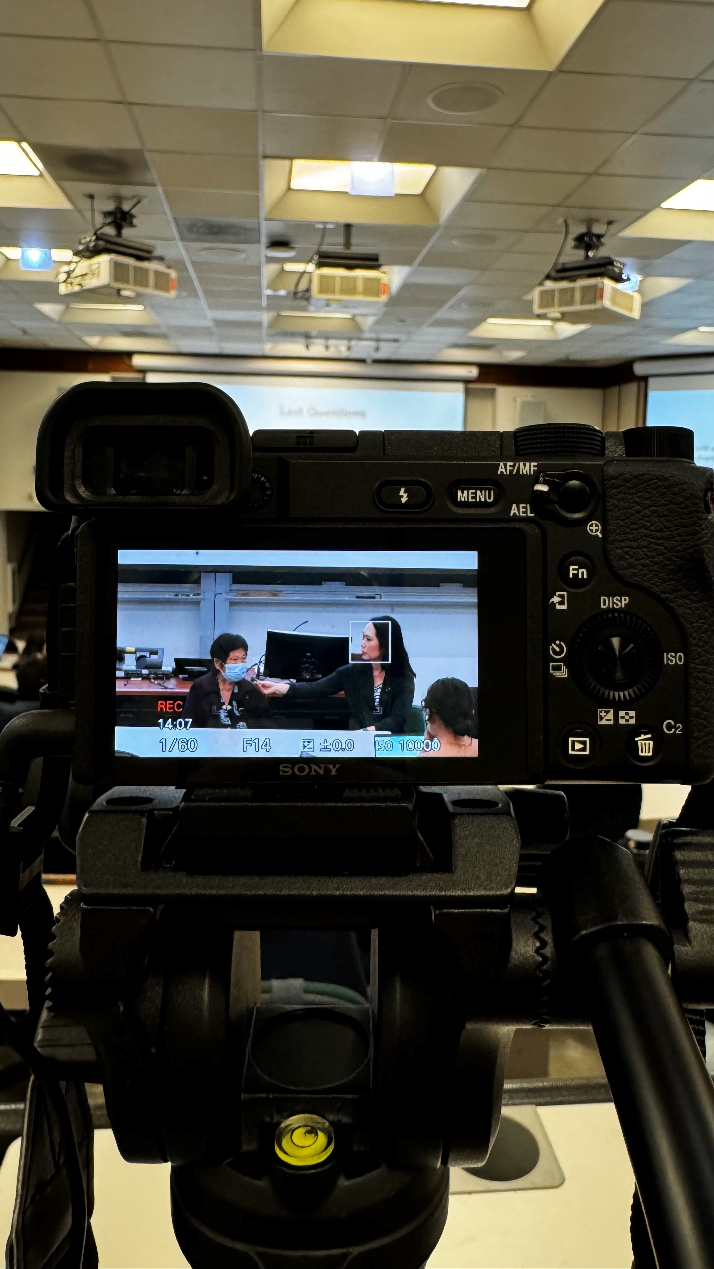 Behind the scenes photo of camera recording panelists